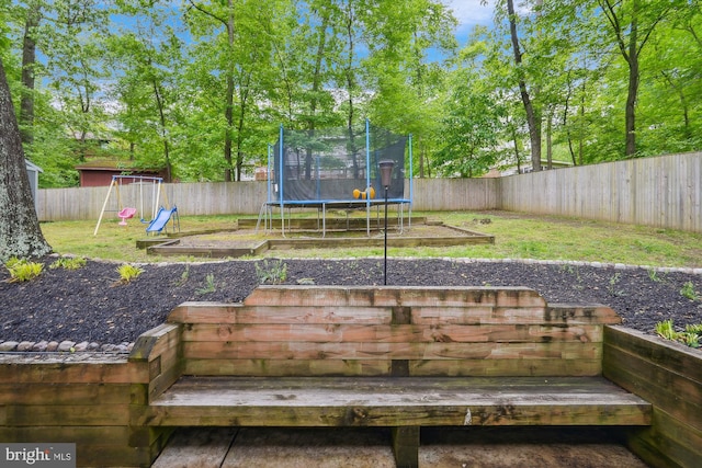 15109 Watergate Rd, Silver Spring, MD 20905 - wooden terrace featuring a trampoline and a playground