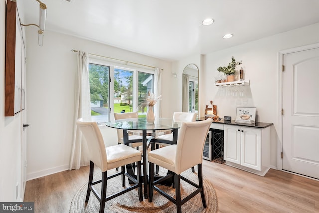 15109 Watergate Rd, Silver Spring, MD 20905 - dining space featuring light wood-type flooring, a bar, recessed lighting, baseboards, and arched walkways
