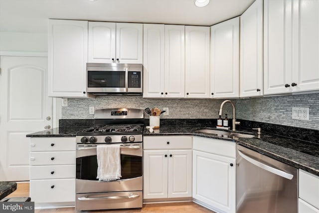 15109 Watergate Rd, Silver Spring, MD 20905 - kitchen featuring stainless steel appliances, a sink, dark stone countertops, and backsplash