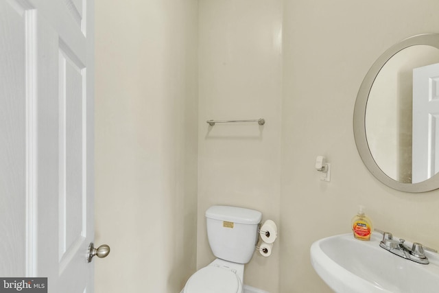 bathroom with toilet and a sink