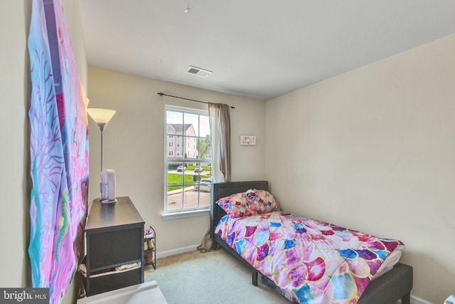 carpeted bedroom featuring baseboards and visible vents