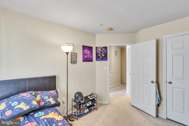 bedroom featuring baseboards, visible vents, and light carpet