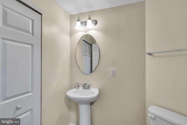 half bath featuring toilet