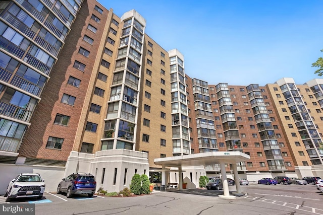 view of building exterior with uncovered parking