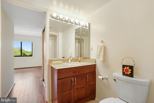 bathroom featuring vanity, toilet, and wood finished floors