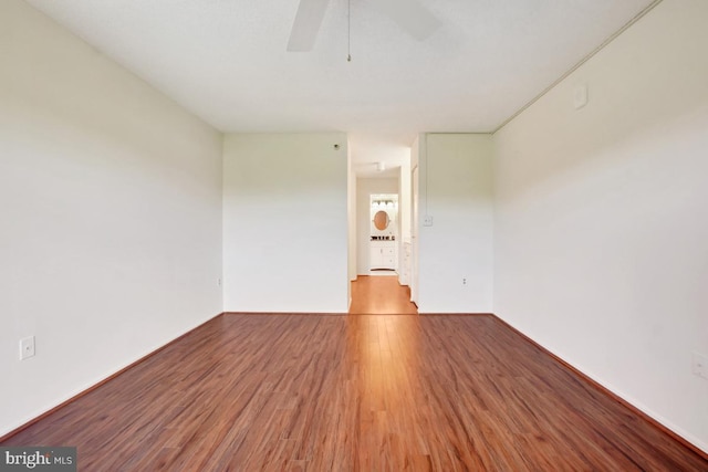 unfurnished room with ceiling fan and wood finished floors