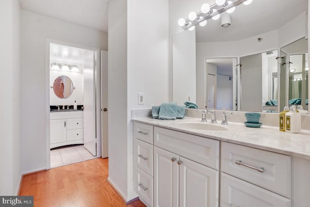 bathroom with vanity and wood finished floors