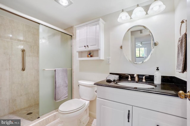 full bath with vanity, tile patterned floors, a stall shower, and toilet