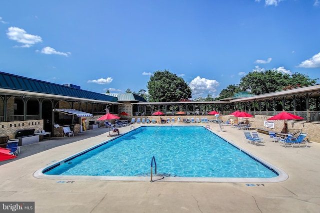 community pool featuring fence and a patio