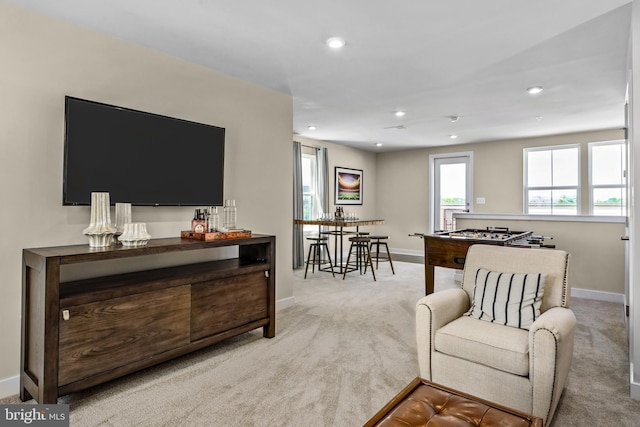 carpeted living room with recessed lighting and baseboards