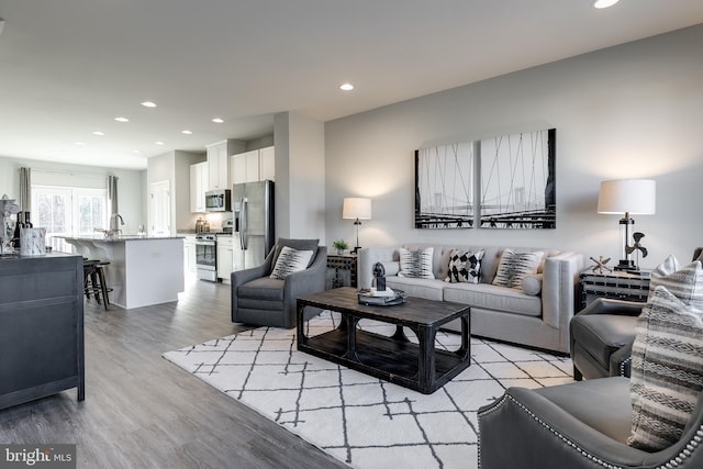 living area featuring recessed lighting and light wood-type flooring