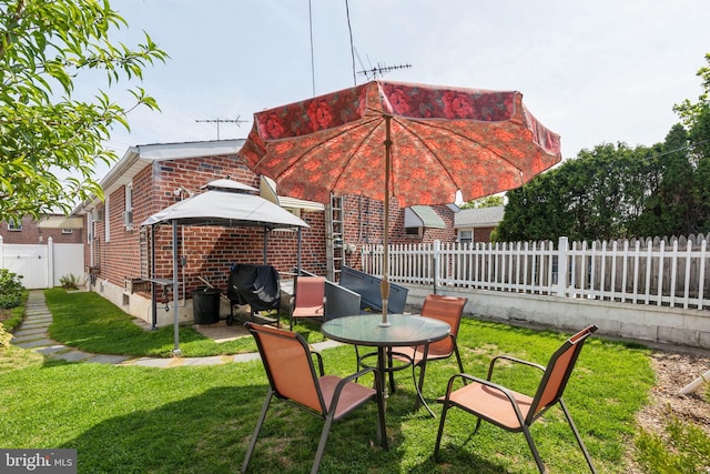 exterior space featuring a patio, brick siding, a fenced backyard, and a lawn