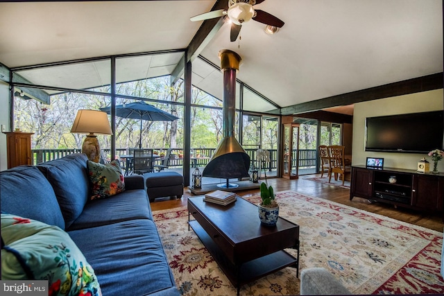 living room featuring ceiling fan, beam ceiling, high vaulted ceiling, a sunroom, and wood finished floors
