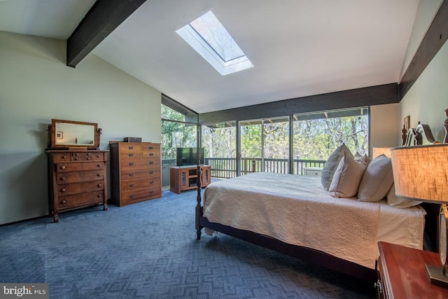 carpeted bedroom with vaulted ceiling with skylight