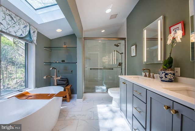 full bath with a sink, marble finish floor, a stall shower, and a skylight
