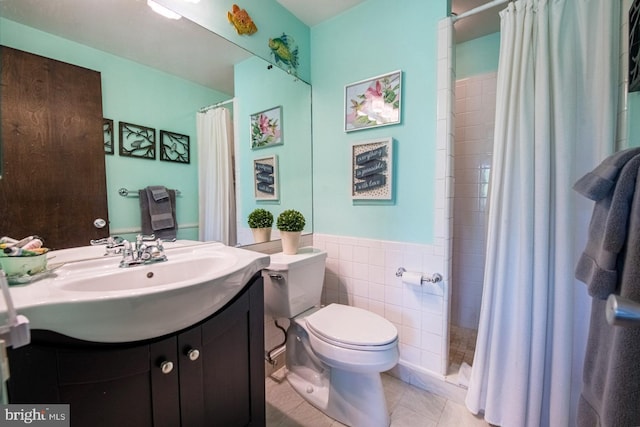 bathroom featuring toilet, tile walls, a shower with shower curtain, and vanity