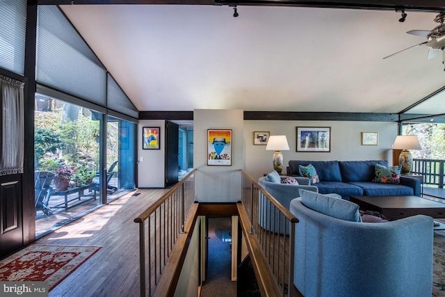 living room with track lighting, ceiling fan, wood finished floors, and lofted ceiling