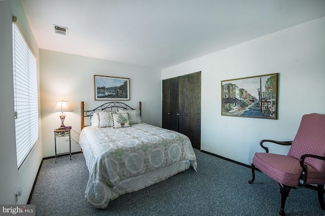 bedroom with visible vents, carpet, baseboards, and multiple windows