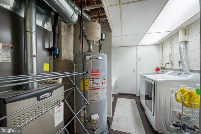 interior space featuring water heater, separate washer and dryer, heating unit, and laundry area