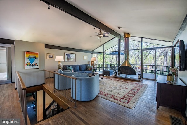 living room featuring track lighting, vaulted ceiling with beams, a ceiling fan, and wood finished floors