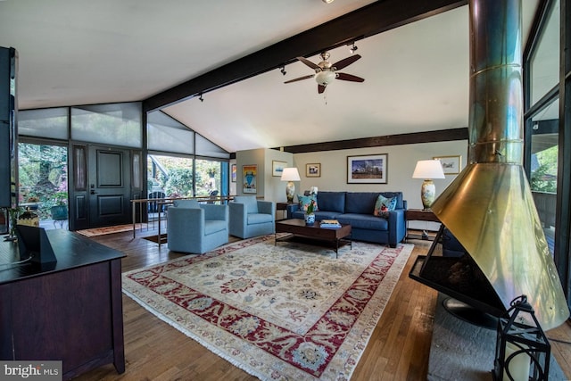 living room featuring vaulted ceiling with beams, wood-type flooring, a ceiling fan, and rail lighting