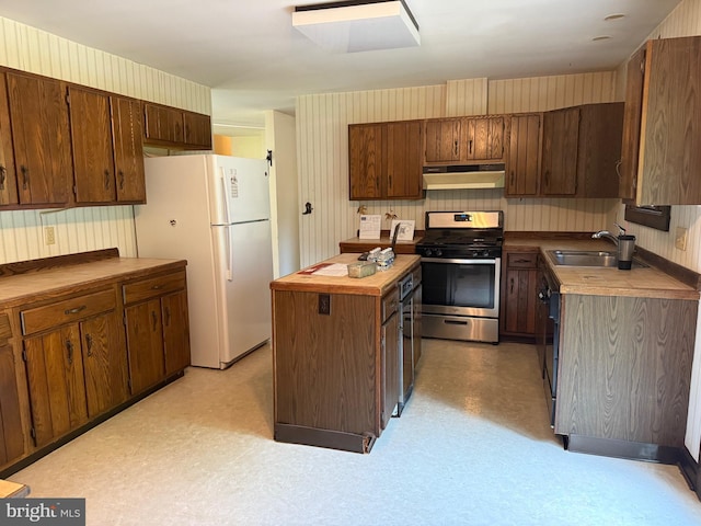 1184 Reservoir Rd, Honey Brook, PA 19344 - kitchen featuring stainless steel gas stove, under cabinet range hood, a sink, a kitchen island, and light flooring