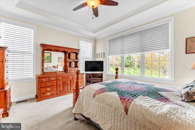 bedroom featuring a raised ceiling, visible vents, ornamental molding, and carpet floors