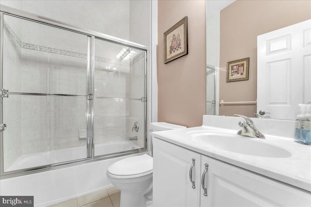 full bathroom with tile patterned floors, vanity, toilet, and enclosed tub / shower combo