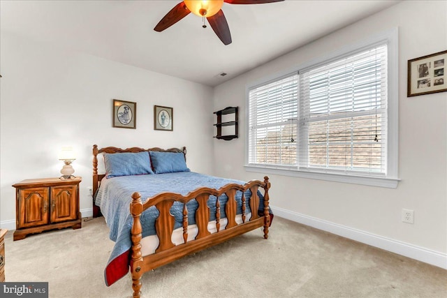 bedroom featuring ceiling fan, baseboards, and light carpet