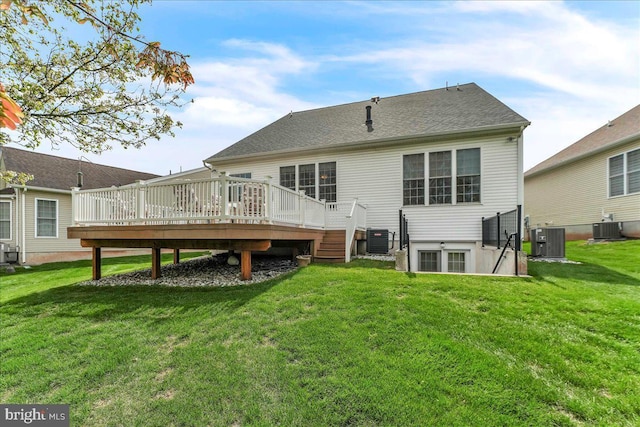 rear view of house featuring a lawn, a wooden deck, and central AC unit