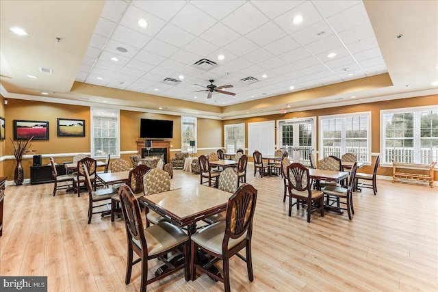 dining area featuring a paneled ceiling, visible vents, and a raised ceiling