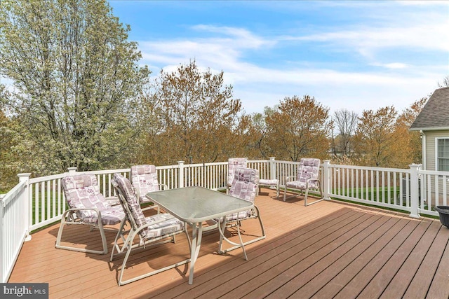 wooden terrace featuring outdoor dining space