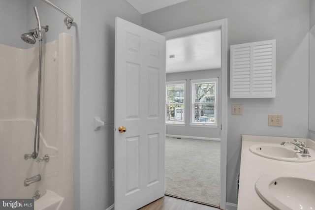 451 Lovell Ct, Hummelstown, PA 17036 - bathroom featuring double vanity, a sink, washtub / shower combination, and baseboards