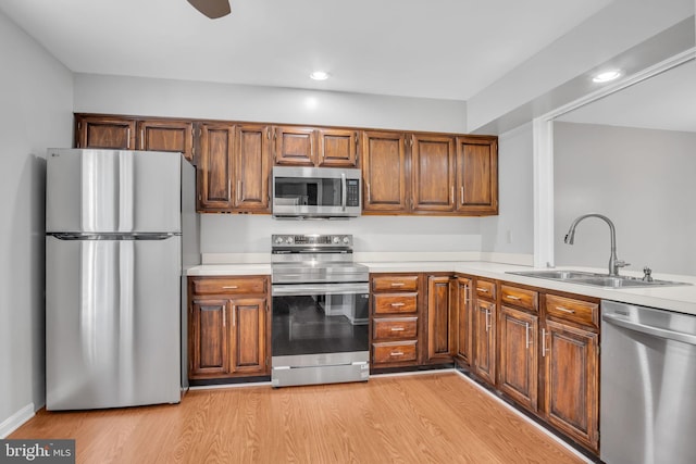 451 Lovell Ct, Hummelstown, PA 17036 - kitchen featuring appliances with stainless steel finishes, light countertops, light wood-style flooring, and a sink