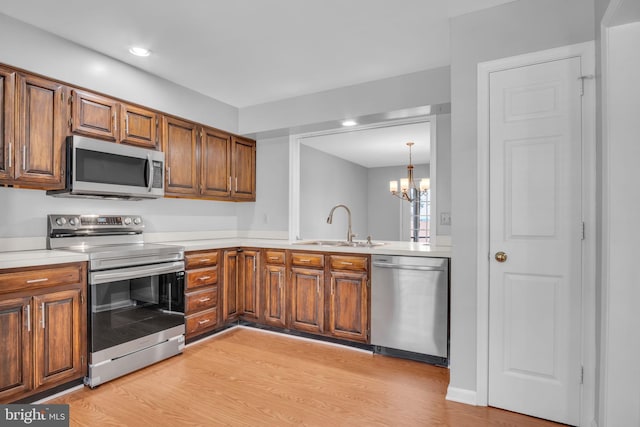 451 Lovell Ct, Hummelstown, PA 17036 - kitchen featuring appliances with stainless steel finishes, light countertops, and brown cabinets