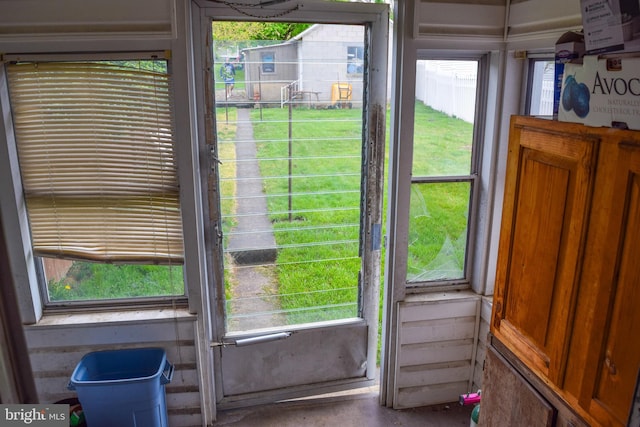 doorway to outside with concrete floors