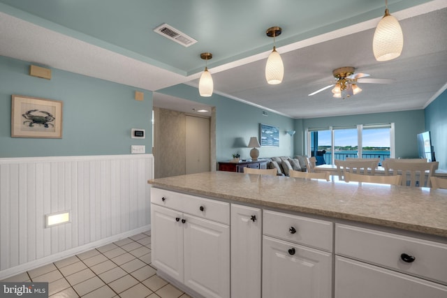 kitchen featuring white cabinets, light countertops, visible vents, and ceiling fan