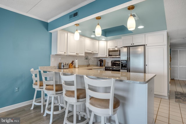 kitchen with stainless steel microwave, a peninsula, a sink, black range with electric stovetop, and fridge with ice dispenser