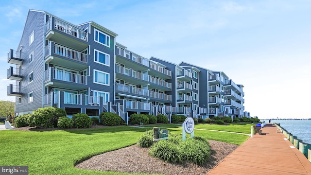 view of home's community with a yard and a water view