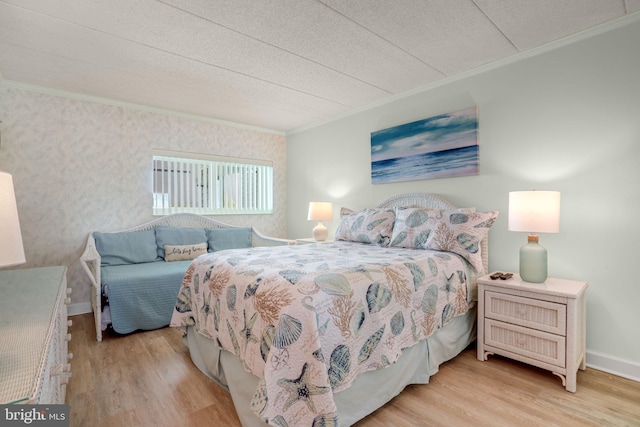 bedroom with baseboards, ornamental molding, a textured ceiling, and wood finished floors