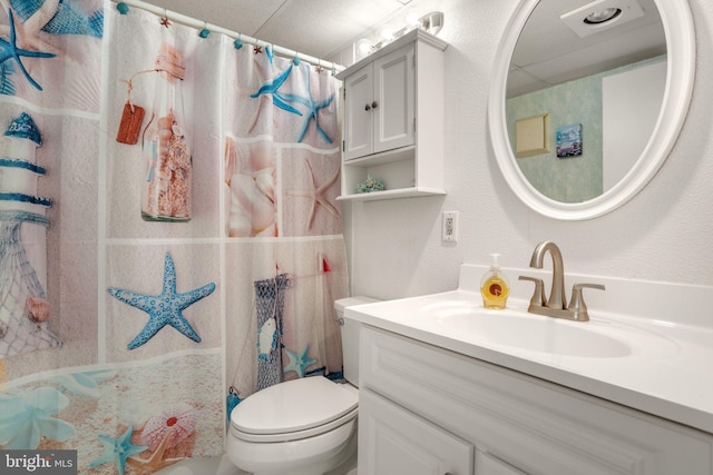 full bathroom with toilet, vanity, and curtained shower