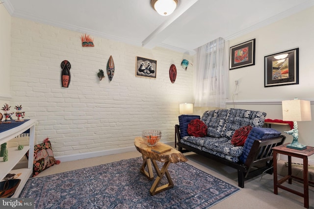 carpeted living room featuring beamed ceiling and brick wall