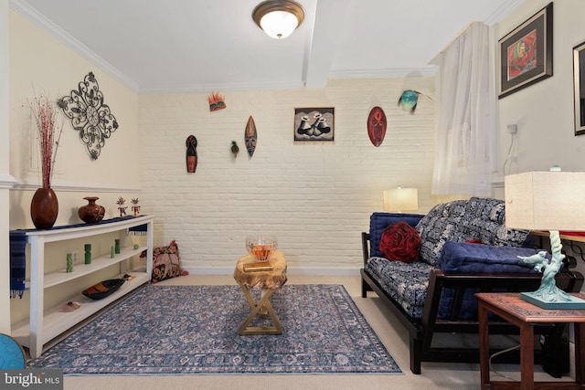 sitting room featuring ornamental molding and brick wall