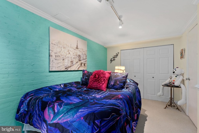 carpeted bedroom featuring ornamental molding and a closet