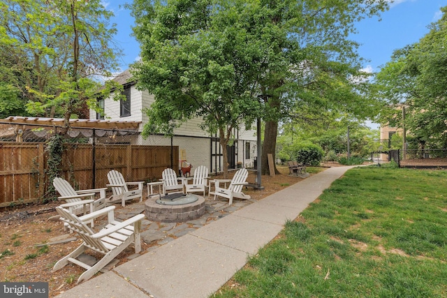 view of yard with a patio, a fire pit, and fence