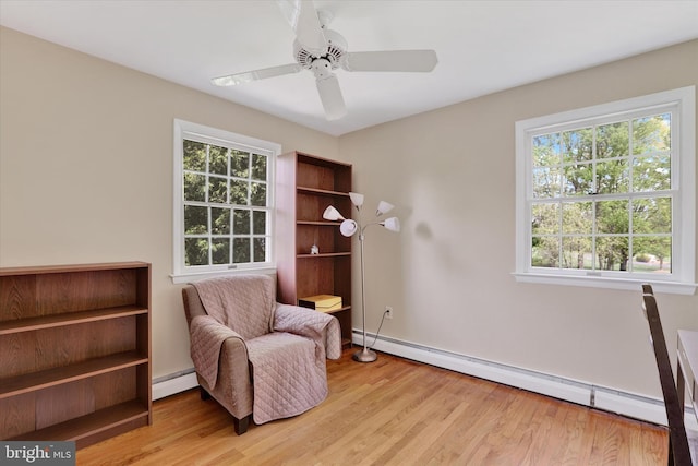 83 Winding Ln, Newtown, PA 18940 - living area with baseboards, a ceiling fan, a baseboard heating unit, and wood finished floors