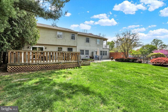 83 Winding Ln, Newtown, PA 18940 - back of property with a lawn, a deck, fence, and a patio