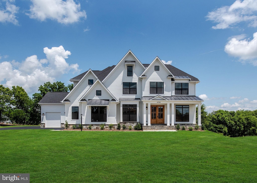 Gravenstein Ct, Winchester, VA 22602 - modern farmhouse style home with a standing seam roof, a front lawn, metal roof, and an attached garage