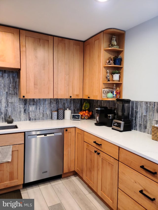 kitchen with decorative backsplash, open shelves, light countertops, dishwasher, and a sink