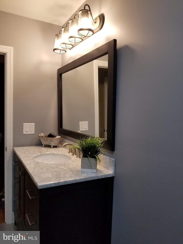 bathroom featuring vanity and a notable chandelier